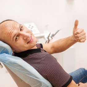 man smiling after getting dental implants in Rocky Hill