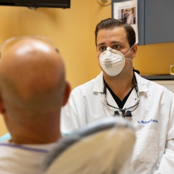 Dentist talking to dental patient