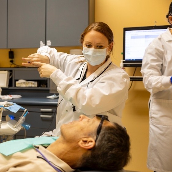 Dentist demonstrating dental treatment for dentistry patient