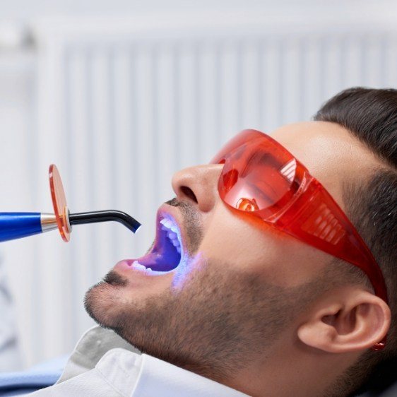 Dental patient receiving cosmetic dental bonding treatment