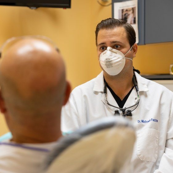 Dentist discussing tooth extractions options with dental patient