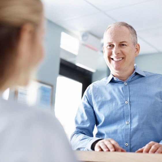 Man discussing the costs of dental implants