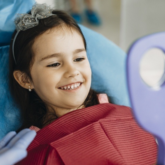 Young dental patient smiling during children's dentistry checkup and teeth cleaning visit