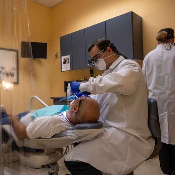 Dentist providing preventive dentistry checkup and teeth cleaning