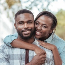 Man and woman with healthy smiles after preventive dentistry